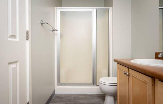 A white toilet sits next to a sink in a bathroom.
