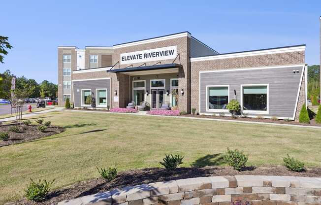 The front of the Elevate Riverview building is shown with a clear blue sky in the background.