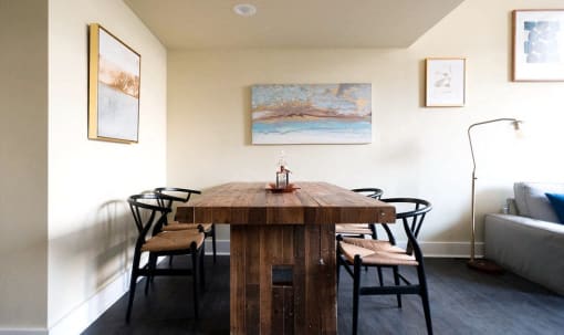 a dining room with a wooden table and black chairs