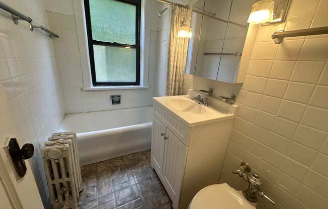 a bathroom with a sink toilet and a tub