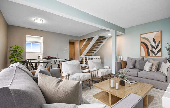 a living room with couches and chairs and a table