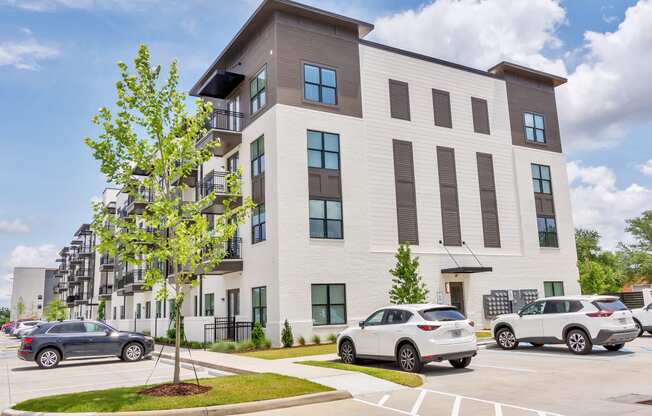 a new apartment building with cars parked in front of it