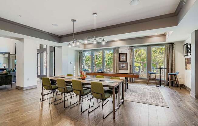 A modern dining room with a long table and chairs.
