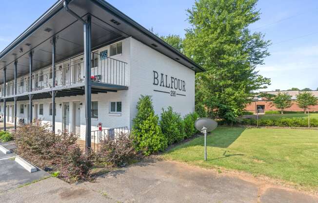 a white building with a satellite dish in front of it  at Balfour 296, Lilburn, 30047