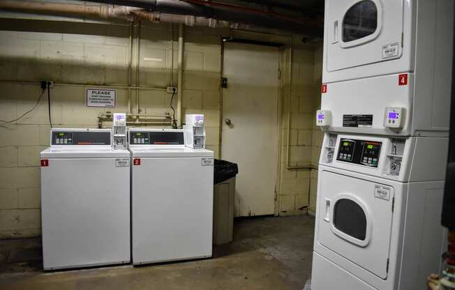 Community laundry room with two washers and two dryers