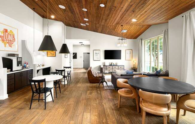 a living room with a table and chairs and a kitchen