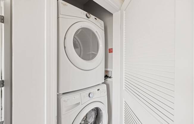 a washer and dryer in a white utility room