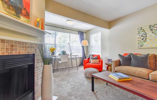 a living room with a fireplace and a large window  at Riverset Apartments, Memphis