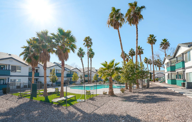 a swimming pool with palm trees in front of houses