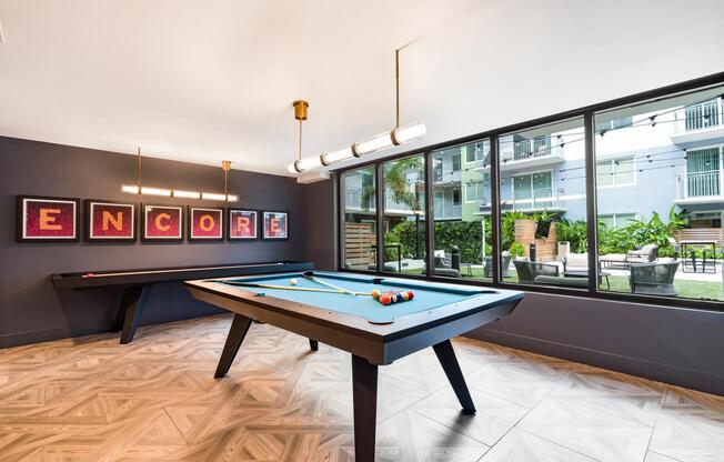 Part of Modera Encore's standout amenity collection, the game room features a billiards table, contemporary finishes, and seamless access to outdoor gathering spaces for recreation and socializing.
