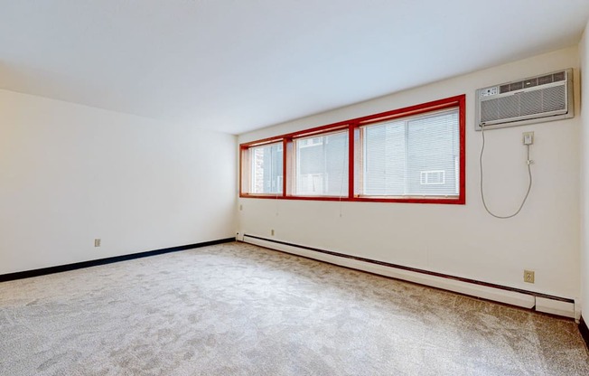 a bedroom with white walls and carpet