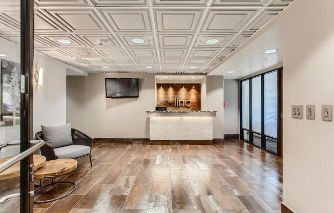 a lobby with a reception desk and a tv