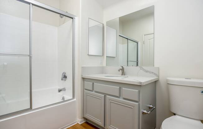 a bathroom with a sink toilet and a shower