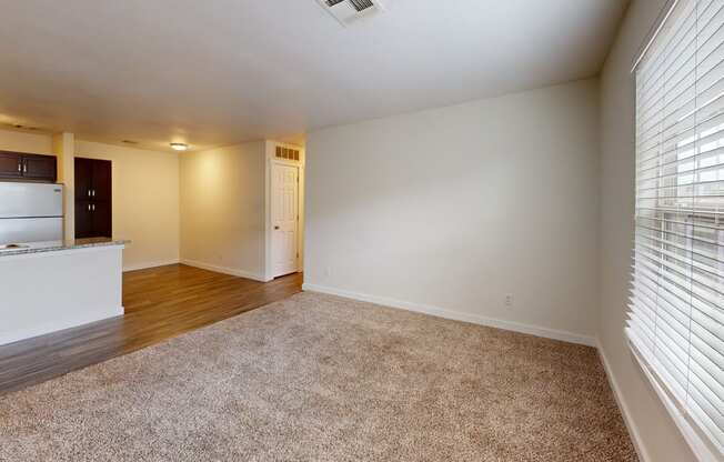 a bedroom with a large window and a kitchen in the background at Bennett Ridge Apartments, Oklahoma City, OK, 73132