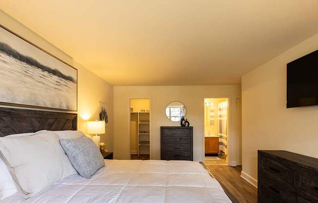 a bedroom with a bed and lamps on the wall