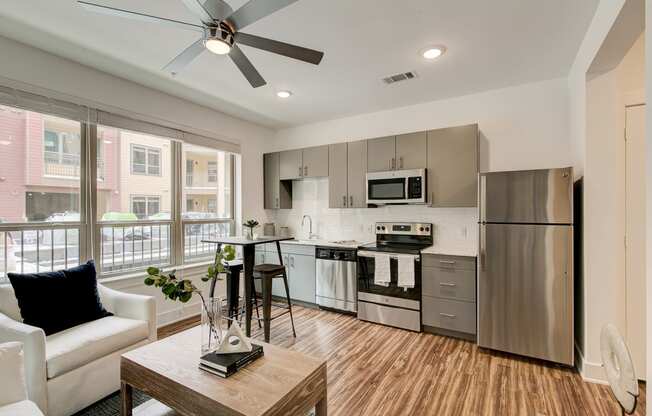 a kitchen with stainless steel appliances and a ceiling fan