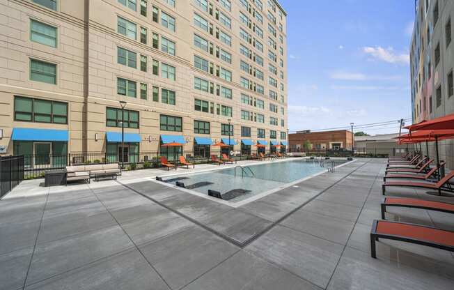 a large swimming pool in front of a large building  at The Icon, Richmond