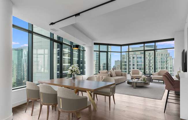a large living room with a large table and chairs and a view of the city at Cassidy on Canal, Chicago, IL
