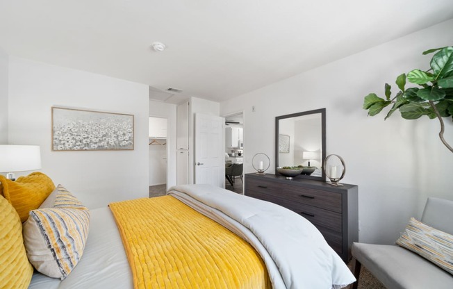 a bedroom with a yellow bed and a yellow blanket