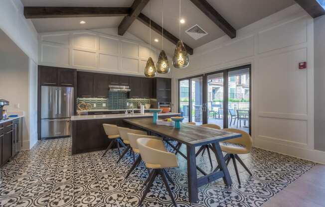 a kitchen with a long wooden table and yellow chairs