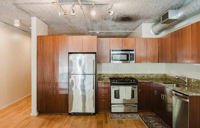 A kitchen with wooden cabinets and stainless steel appliances.