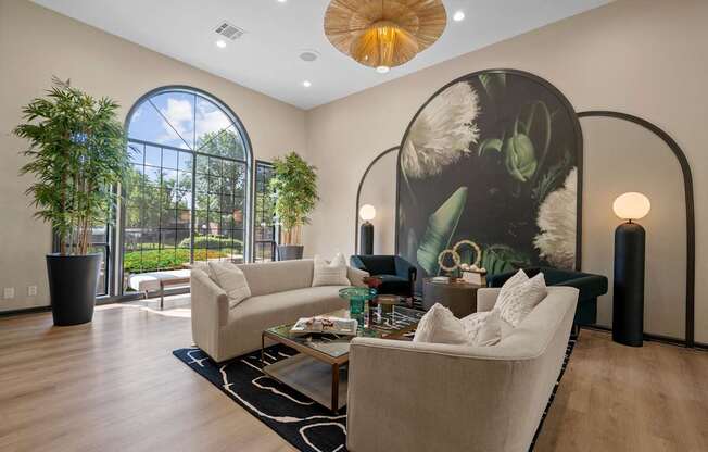 A living room with a large couch and a large painting on the wall.