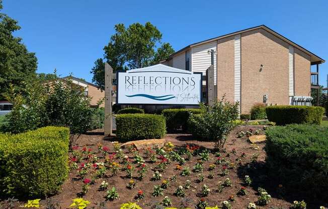 A sign for Reflections at Keefe is in front of a building.