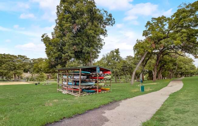a kiosk in a park next to a path