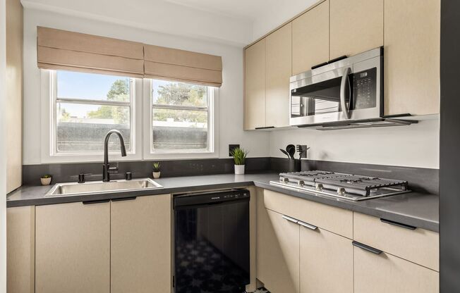 A 4 Bedroom, 3 Bathroom apartment with common areas and a fully functional kitchen at 1476 Malcolm Ave.