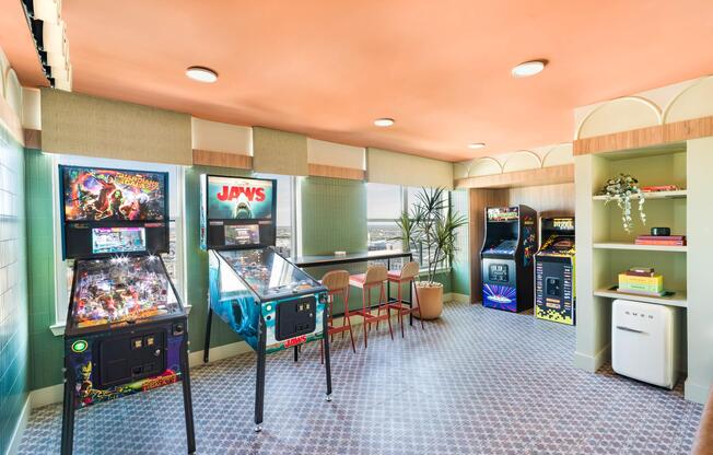 Our Wes Anderson-inspired vintage arcade room features pinball and classic games, offering a playful retreat with skyline views in the heart of Dallas.