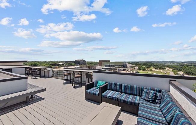 a rooftop terrace with couches and tables