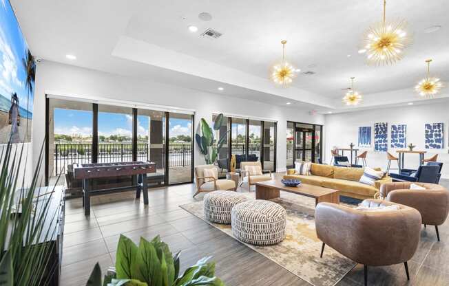 a living room with couches and chairs and a pool table