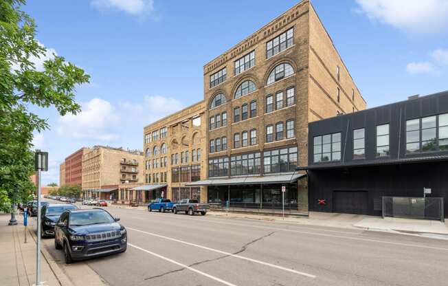 a large brick building on a city street at Gaar Scott Historic Lofts, Minnesota, 55401