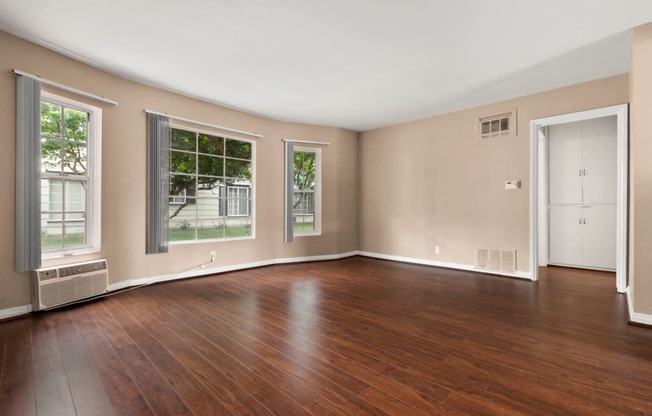 Apartments for Rent in Van Nuys - Colonial Manor Expansive Living Room with Hardwood-Style Flooring and Multiple Large Windows