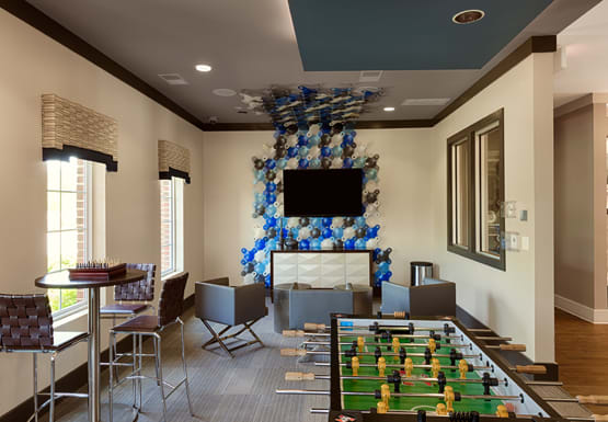 Game room with TV, chairs, tables and foosball