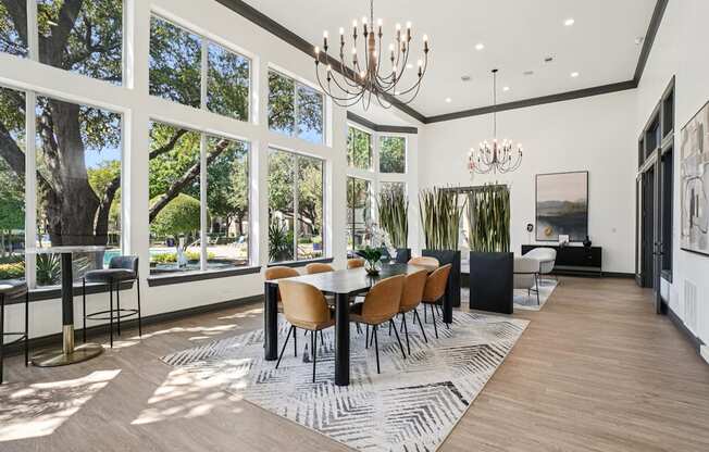 A modern dining room with a large table and chairs.