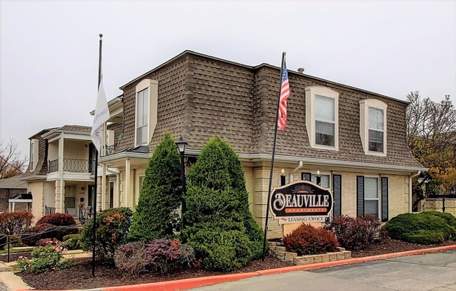 Exterior image of building with sign and flags