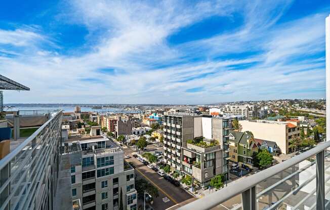 views of the city and the ocean from an apartment balcony