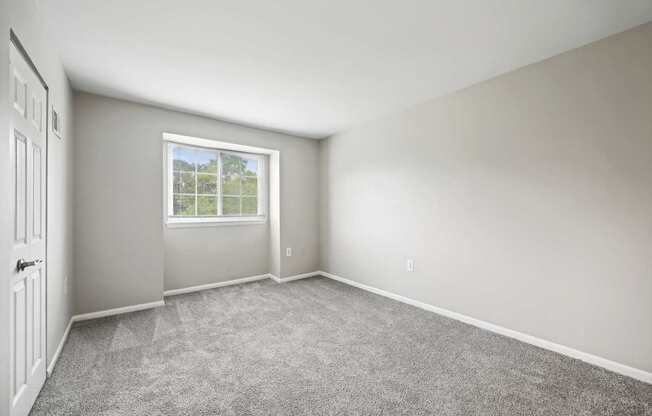 an empty room with carpet and a window at ReNew Odenton