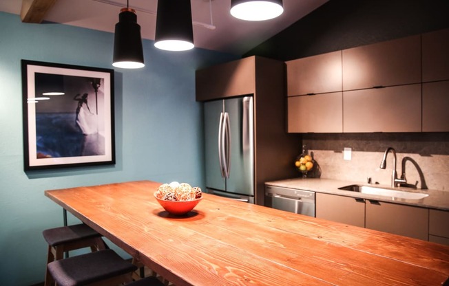 a kitchen with a wooden table with a bowl of popcorn on it