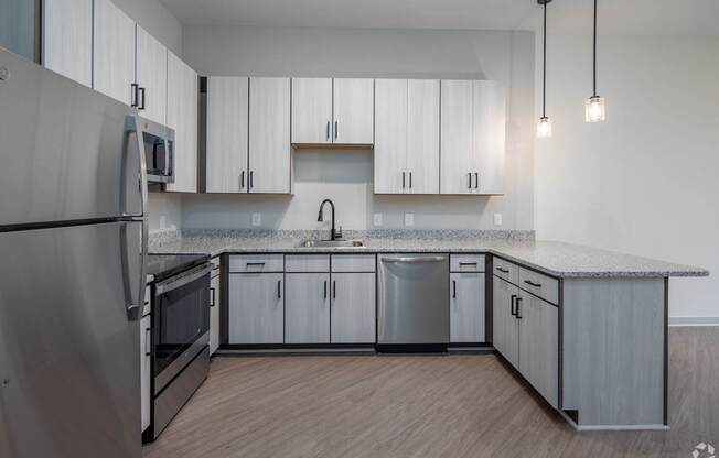 A modern kitchen with stainless steel appliances and wooden cabinets.