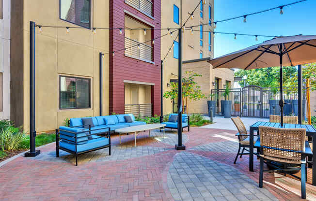 A patio with a blue sofa and chairs.