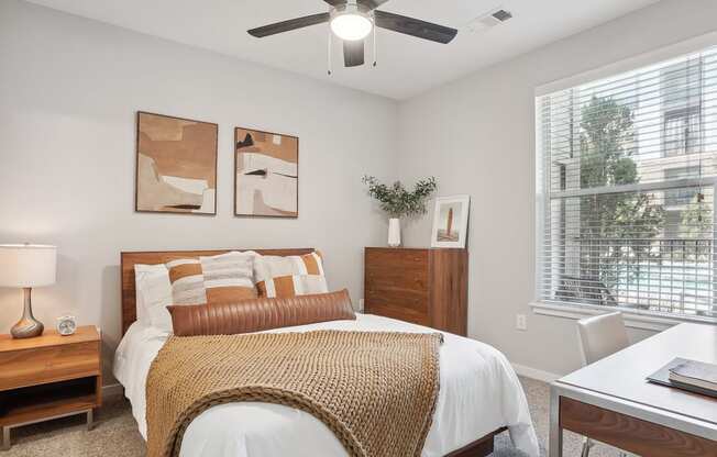 a bedroom with a bed and a ceiling fan