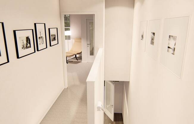 a hallway with white walls and pictures on the wall at Brownstones at Palisade Park Townhomes, Broomfield, CO