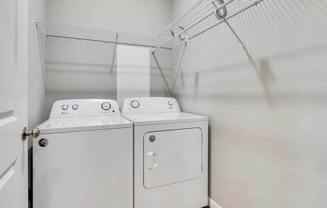 a washer and dryer in a laundry room with white walls. Circle Pines, MN Lexington Lofts