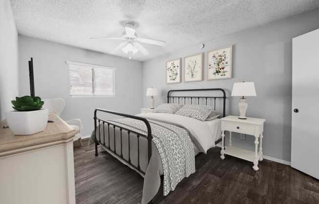 a bedroom with a bed and a ceiling fan