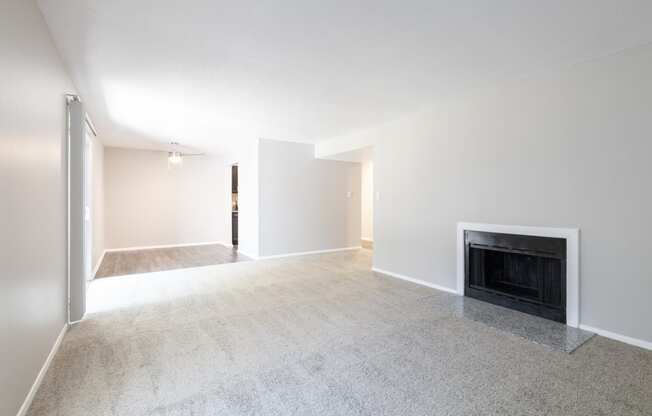 Open Dining and Living Room with a Fireplace in the Two Bedroom Two Bath Apartment at Woodbridge Apartments Bloomington