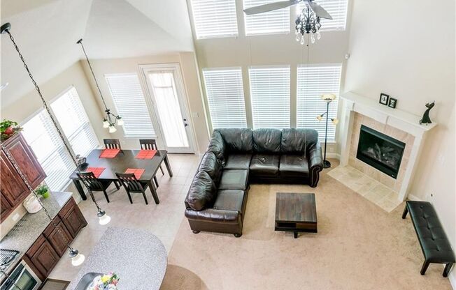 Grand entry, Open floor plan with high ceiling, Spacious rooms, Elegant kitchen featuring stainless steel appliances.
