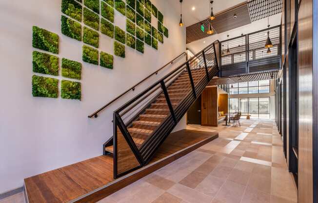 a staircase in a building with plants on the wall