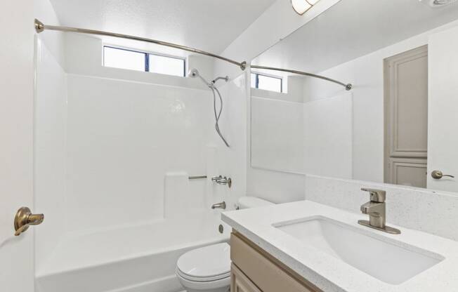 a bathroom with a sink toilet and a shower